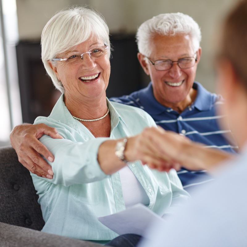 Older couple speaking with solar lawyers